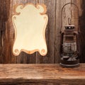 Lamp oil lantern certificate old wooden table Royalty Free Stock Photo