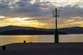 Lamp post on a dock against a cloudy sky at dusk Royalty Free Stock Photo