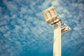 Lamp post electricity industry with blue sky background. Spotlight tower, vintage tone. Royalty Free Stock Photo