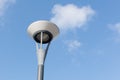 Lamp post and fluffy clouds in blue sky