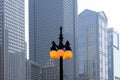 Lamp post with lit ball lights against tall modern buildings in downtown Chicago Royalty Free Stock Photo