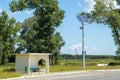 Lamp post with solar panel system on road with blue sky and trees. Autonomous street lighting using solar panels. Street lamp, on Royalty Free Stock Photo