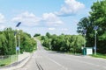 Lamp post with solar panel system on road with blue sky and trees. Autonomous street lighting using solar panels. Street lamp, on Royalty Free Stock Photo