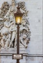 Lamp post stands before The Arc de Triomphe on the Place de Charles De Gaulle-Paris France Royalty Free Stock Photo