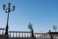 lamp posts on a pier with railing at sunny spring day with clear blue sky Royalty Free Stock Photo