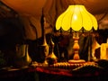 Lamp shining on beautiful eastern metal teapots
