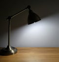 Lamp shining down on empty desk space