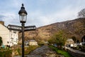 Lamp with signpost to porthmadog & Caernarfon on River bridge in Beddgelert, Wales