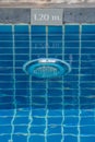 Lamp in swimming pool with warning sign showing the depth of the swimming pool. Royalty Free Stock Photo