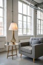 Lamp on table next to grey settee in white loft interior Royalty Free Stock Photo