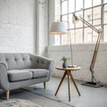 Lamp on table next to grey settee in white loft interior Royalty Free Stock Photo