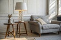 Lamp on table next to grey settee in white loft interior Royalty Free Stock Photo