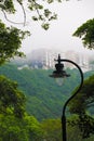 A lamp turned off on a cloudy day surrounded by vegetation Royalty Free Stock Photo