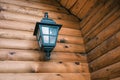 Lamp on the wall of an old wooden log house Royalty Free Stock Photo