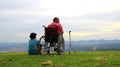 2023-05-01:Lampang Thailand:A disabled man sits in a wheelchair-accessible vehicle, while an elderly woman sits beside him on the Royalty Free Stock Photo