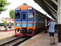 2023-05-01:Lampang Thailand:Male tourist standing at the platform to take photos of the train