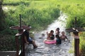 2023-05-01:Lampang Thailand:Many children were having fun playing in the small canal at the rice fields