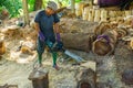 Worker cutting wood to make furniture