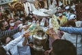 LAMPHUN, THAILAND - MAY 15, 2022: Monks and people pour auspicious water into large bowls to pay homage to the Buddha`s relics