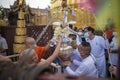 LAMPHUN, THAILAND - MAY 15, 2022: Monks and people pour auspicious water into large bowls to pay homage to the Buddha`s relics