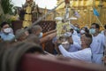 LAMPHUN, THAILAND - MAY 15, 2022: Monks and people pour auspicious water into large bowls to pay homage to the Buddha`s relics Royalty Free Stock Photo