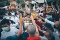 LAMPHUN, THAILAND - MAY 15, 2022: Monks and people pour auspicious water into large bowls to pay homage to the Buddha`s relics