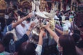 LAMPHUN, THAILAND - MAY 15, 2022: Monks and people pour auspicious water into large bowls to pay homage to the Buddha`s relics Royalty Free Stock Photo