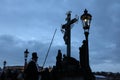 Lamplighter lights a street gas light at the Charles Bridge in P