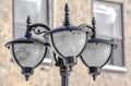 Lampost with Three Lanterns by Building Royalty Free Stock Photo