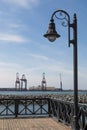 Lamppost Across Harbor From Shipping Cranes in Ensenada Harbor