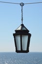 Lantern in a street sale in front of the sea