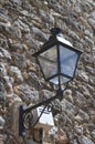 Lamppost lantern attached to medieval wall. LED light.Light off