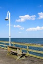 Lamppost Next to Bench on Ocean View Fishing Pier Royalty Free Stock Photo