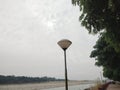 a lamppost by the sidewalk along the coastline in Chenab river Akhnoor