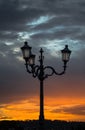 Lampposts in Italy at sunset and dramatic sky Royalty Free Stock Photo