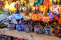 Lamps, candles, dishes and crafts in the street stalls of the medieval fair