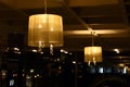 Lamps hanging from the ceiling radiate light in a restaurant Royalty Free Stock Photo