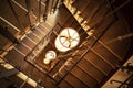 Lamps on long wires hang down to first floor from flight of stairs, top view.