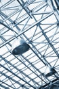 Lamps and metallic girders on glass ceiling