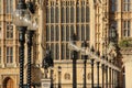 Lamps and the Richard the Lionheart statue outside the Houses of Parliament in London, UK