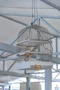 Lampshade made from white painted wooden bird cage. Closeup of birdcage transformed into ceiling lamp with golden color lightbulbs Royalty Free Stock Photo