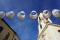 Lampshades in the air. Decorative exterior canvas lampshades. lanterns or lampions above public street above town street