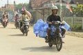 Indonesian couriers carry gallon packages to be sent to customers. customer day