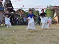 Childrens competiting in sack race. Celebration to welcome Independence day of Indonesia