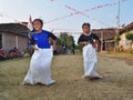 Childrens competiting in sack race. Celebration to welcome Independence day of Indonesia