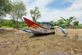 A fishing boat ran aground on a rocky beach