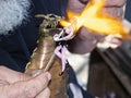 Lampwork - Craftsmans hands forming glass fairy by melting glass with a torch in the form of a dragon