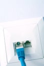LAN cable plugged into the wall outlet Royalty Free Stock Photo