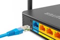 LAN connector plugging in LAN port internet wireless router back side panel 3d Royalty Free Stock Photo