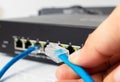 LAN network switch with ethernet cables plugging in Royalty Free Stock Photo
